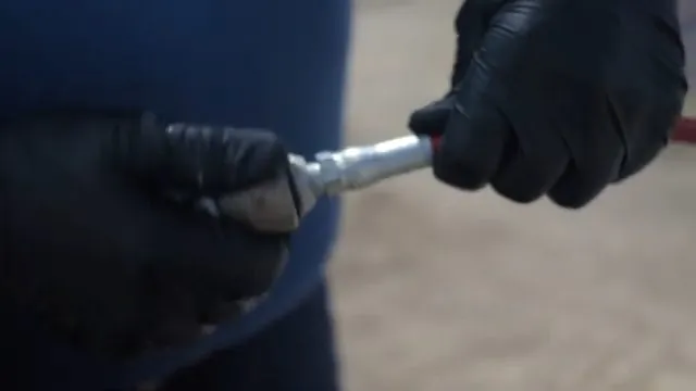Gloved hands holding a hydro-jetting nozzle