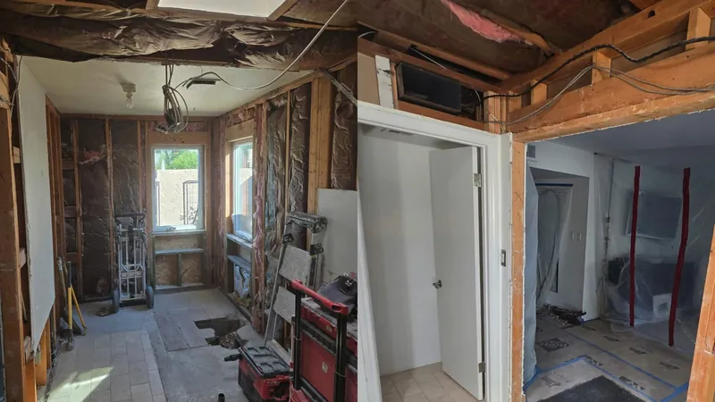 A gutted interior room with open wall framing and a damaged ceiling